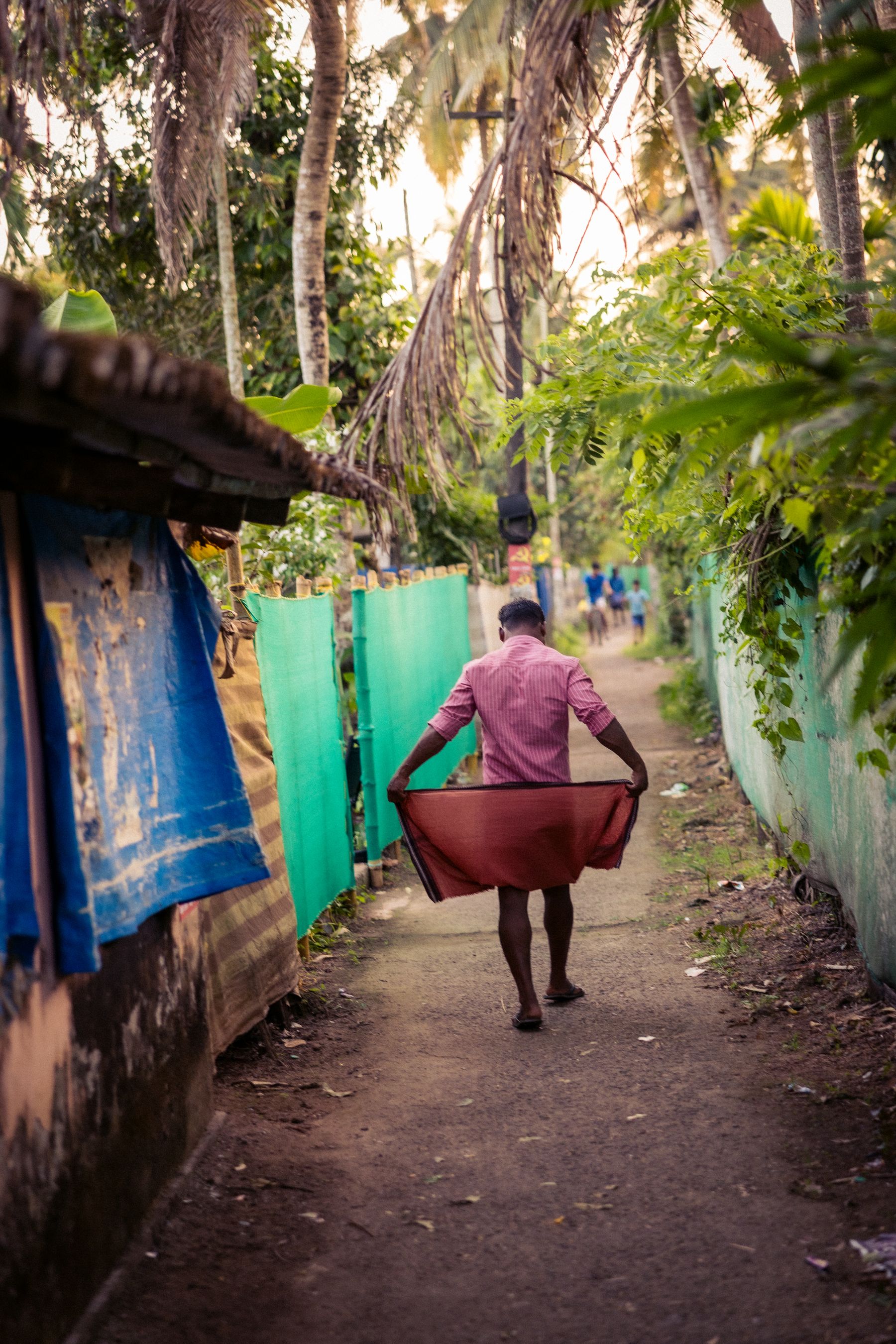 Man Dressing While Walking Through Village Lane